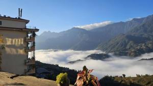 a view of a valley with clouds in the mountains at TIME Restaurant & Homestay Sa Pa in Sapa