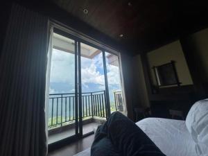 a bedroom with a large window with a view at TIME Restaurant & Homestay Sa Pa in Sapa +17 photos