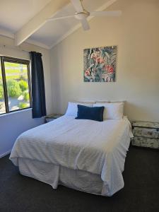 a bedroom with a bed and a window at Rolling Hills Cottage in Tauwhare
