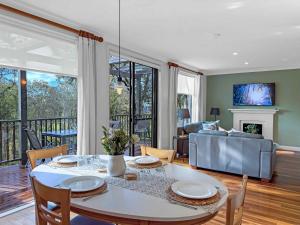 a living room with a table and a couch at Vilamoura in Pokolbin