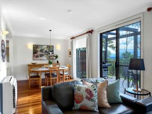 a living room with a couch and a table at Vilamoura in Pokolbin