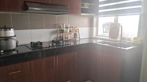 a kitchen with a counter top and a window at Cahaya 382 in Sitiawan +13 photos