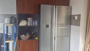 a kitchen with a stainless steel refrigerator at Cahaya 382 in Sitiawan