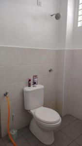 a bathroom with a white toilet in a room at Cahaya 382 in Sitiawan