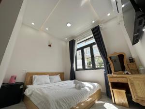 a bedroom with a bed and a dresser and a window at House 1994 in Xuan An