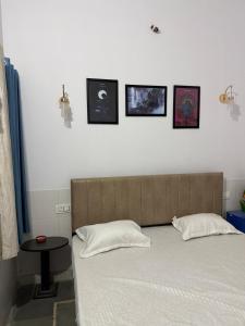 a bed in a room with pictures on the wall at Ajay Niwas in Udaipur