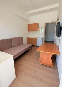 a living room with a couch and a table at Intour in Cholpon-Ata