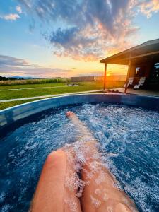 a person swimming in a hot tub with the water at Fajny domek Wójcice in Otmuchów