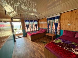 a room with two beds and a couch in a bus at Sumikshas Homestay in Pedong