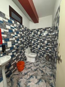 a bathroom with a toilet and a sink at Sumikshas Homestay in Pedong