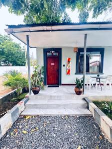 a red door on a house with a table at Easyhomes bungalow apartment in Dar es Salaam