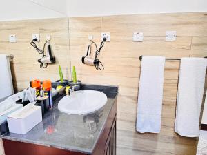 a bathroom with a sink and a mirror at Easyhomes bungalow apartment in Dar es Salaam +36 photos