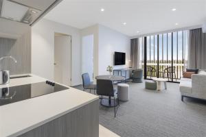 a room with a kitchen and a living room at Quest Watergardens in Taylors Lakes