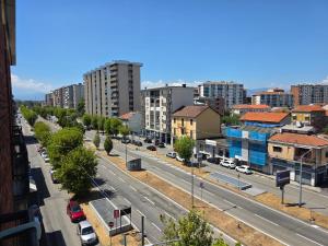 a city street with cars parked on the road at Da Silvia ampio appartamento metro Paradiso in Collegno