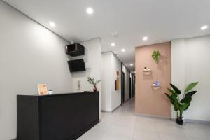 an office lobby with a black counter and a corridor at Cove Atman in Jakarta
