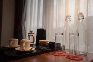a table with two glass bottles on top of it at Tshang RI in Thimphu