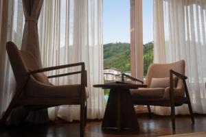 two chairs and a table in front of a window at Tshang RI in Thimphu