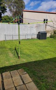 a basketball hoop in a yard with a fence at Green Acres in Gympie in Monkland +9 photos