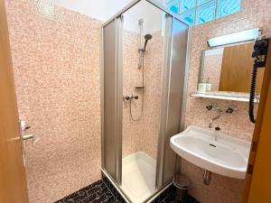 a bathroom with a shower and a sink at Gästehaus Kremser in Weiten +7 photos