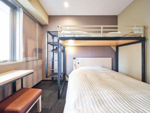a small room with bunk beds and a bench at Super Hotel Kadoma in Kadoma
