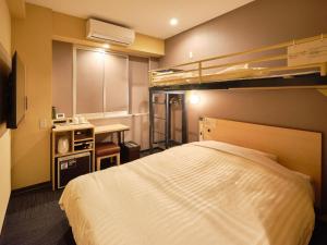 a bedroom with a bed and two bunk beds at Super Hotel Kadoma in Kadoma