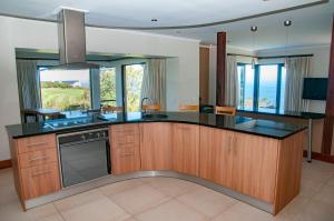 a kitchen with a large island with a counter top at Hippo House in Knysna