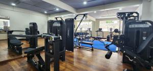 a gym with treadmills and machines in a room at Tshang RI in Thimphu