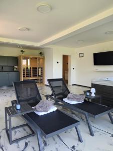 two black tables in a room with a bed at Luni Stay - Jacuzzi, Sauna & Nature Escape in Jastrebarsko