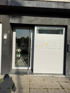a door on a building with a reflection in a window at The North Antwerp Apartment in Antwerp