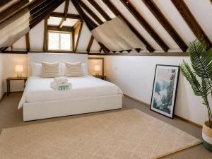 a bedroom with a white bed with a teddy bear on it at Cozy Loft Beach House in Wollongong