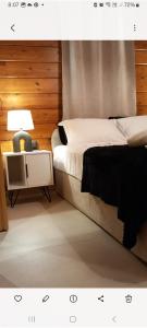 a bedroom with a bed and a table with a lamp at Villa Mareta in Svoronata