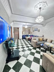 a living room with a checkered floor at Martil in Martil
