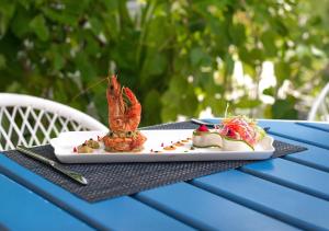a plate of food on a blue table at Kaani Haven Beach in Ukulhas