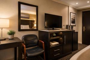 a hotel room with a bed and a desk and a television at The Boards AC in Atlantic City