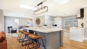 a kitchen with a large island with bar stools at Curra Nardie Ranch in Sutton Forest