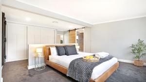 a bedroom with a large bed with a table on it at Curra Nardie Ranch in Sutton Forest