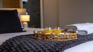two glasses of orange juice in a basket on a bed at Curra Nardie Ranch in Sutton Forest