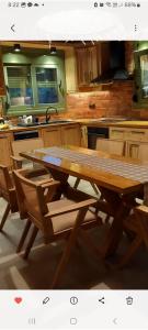 a wooden table and chairs in a kitchen at Villa Mareta in Svoronata +38 photos