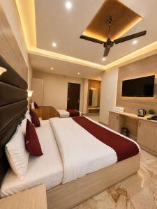 a bedroom with a large bed and a flat screen tv at Grand Vista Retriet- A luxury Mountain View Property In Mussoorie By Lilly in Mussoorie