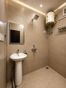 a bathroom with a sink and a mirror at Grand Vista Retriet- A luxury Mountain View Property In Mussoorie By Lilly in Mussoorie