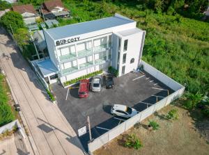 an aerial view of a building with cars parked in a parking lot at ยูพี โคซี่ in Nakhon Nayok