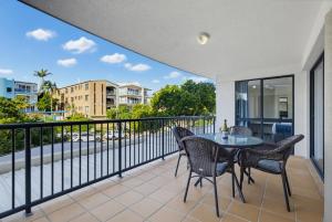 a balcony with a table and chairs on it at Belaire Place Motel Apartments in Caloundra
