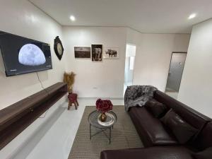 a living room with a couch and a flat screen tv at Serenity Haven in Chongwe