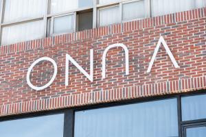 a sign on the side of a brick building at ONUA Gwangalli in Busan