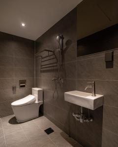 a bathroom with a toilet and a sink at ONUA Gwangalli in Busan +21 photos