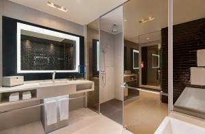 a bathroom with a sink and a shower at W Bangkok Hotel in Bangkok