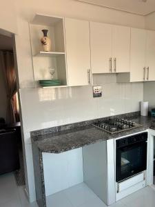 a kitchen with white cabinets and a counter top at Serenity Haven in Chongwe