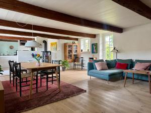 a living room with a blue couch and a table at Fred & Lyst in Stenløse