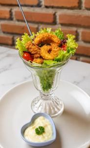 a salad in a glass bowl on a table with a dip at Double view point sibetan in Tenganan