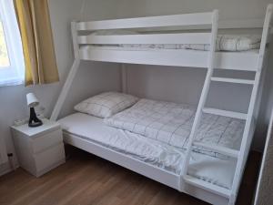 a bedroom with a white bunk bed with a ladder at Ferienwohnung Edith-Maria in Bad Goisern